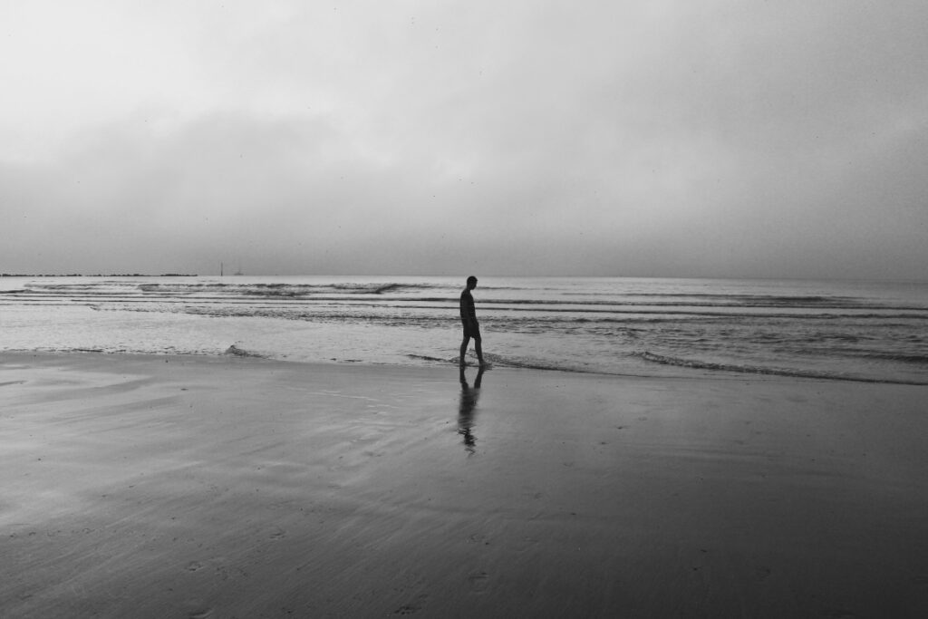 Image of a person walking on the beach